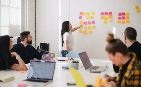 woman placing sticky notes on wall